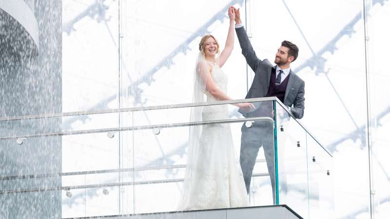 Bride and groom on a lookout bridge at The Leaf