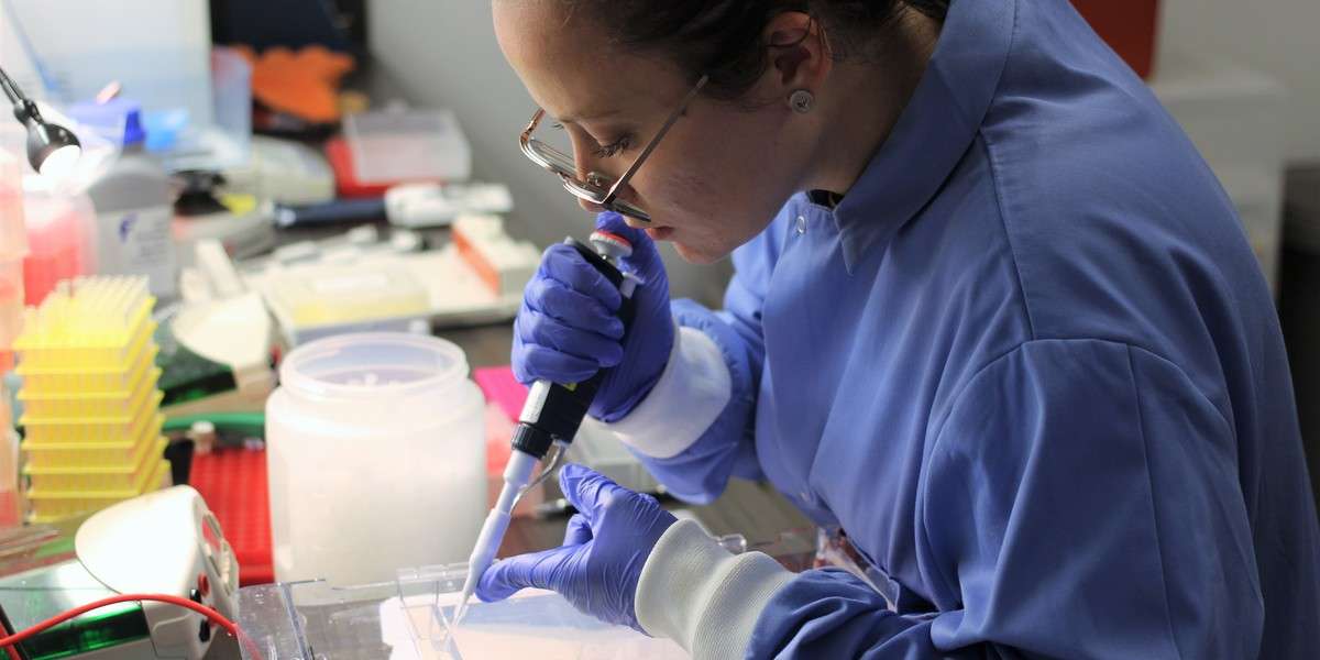 Conservation Specialist in the lab pipetting