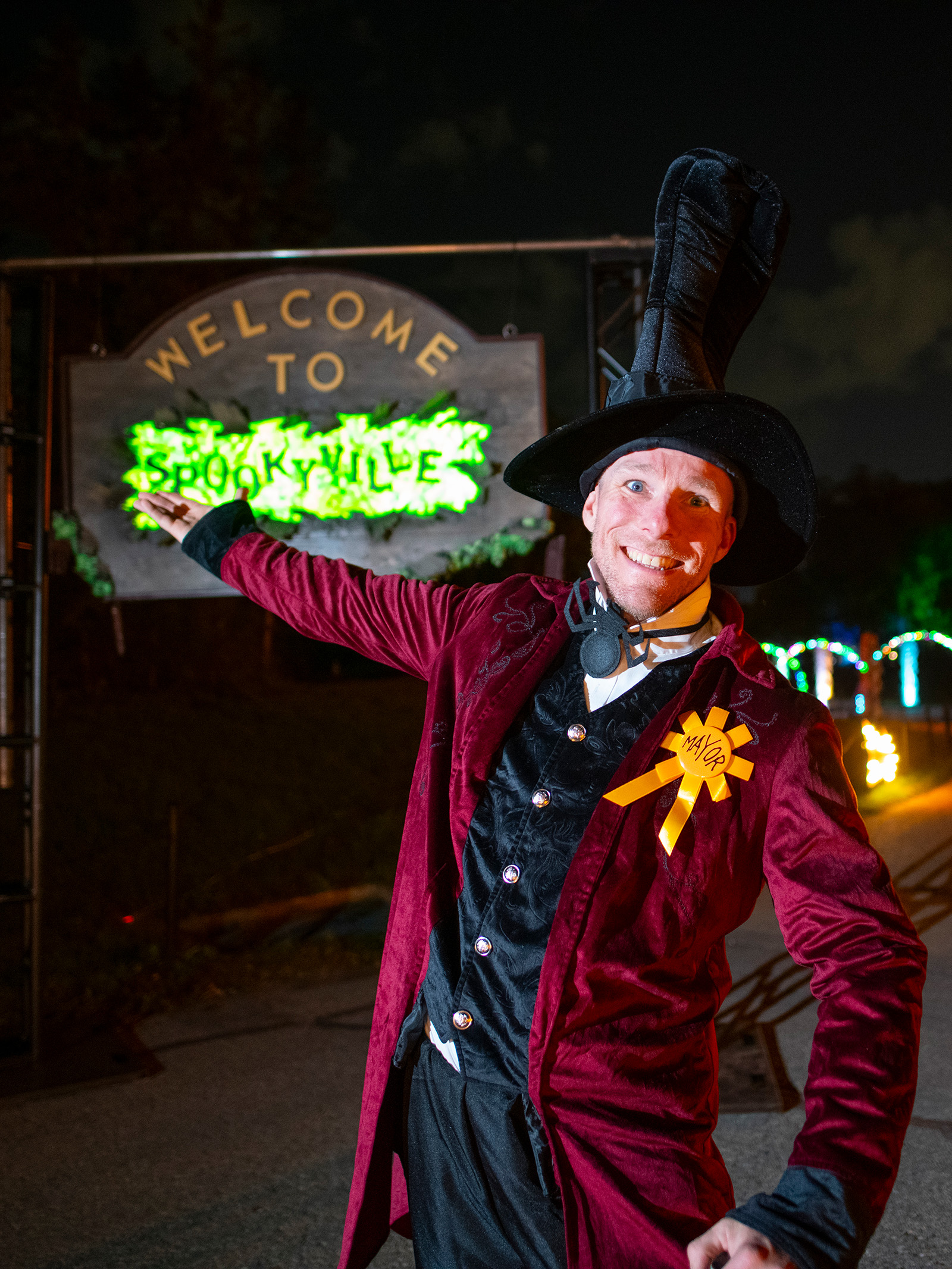 The mayor of Spookyville gestures to welcome guests to the event