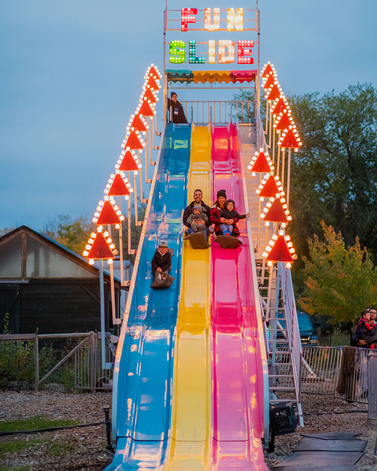 family slides down a giant slide ride