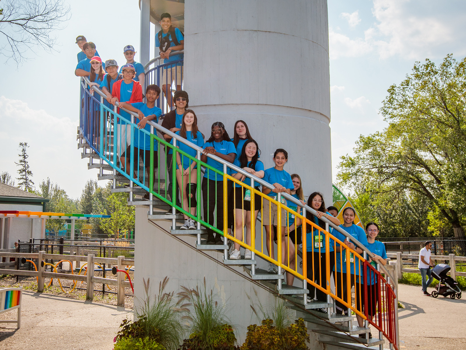 camp volunteers all stand together on a set of stairs outdoors