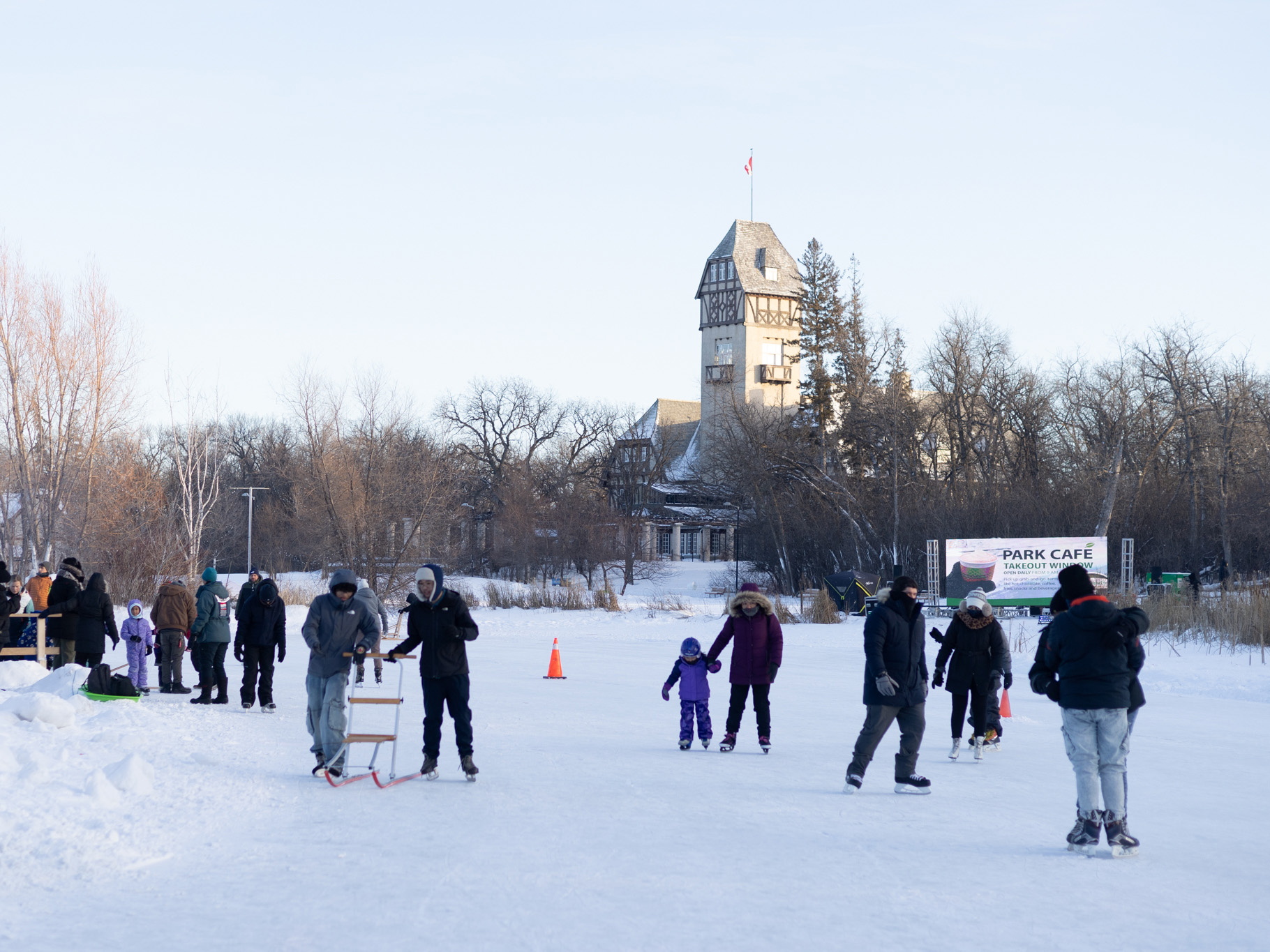 groups of people skate on a frozen duck pond