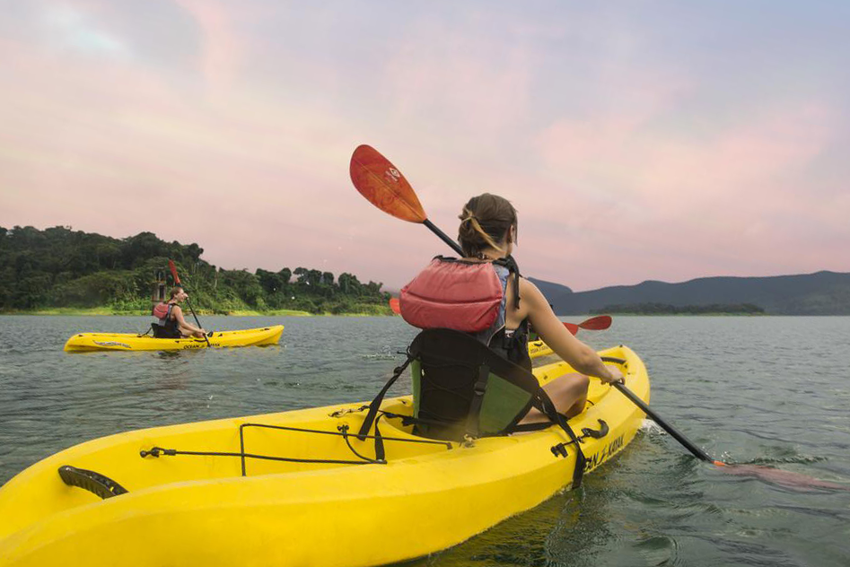 Two people kayak on the ocean